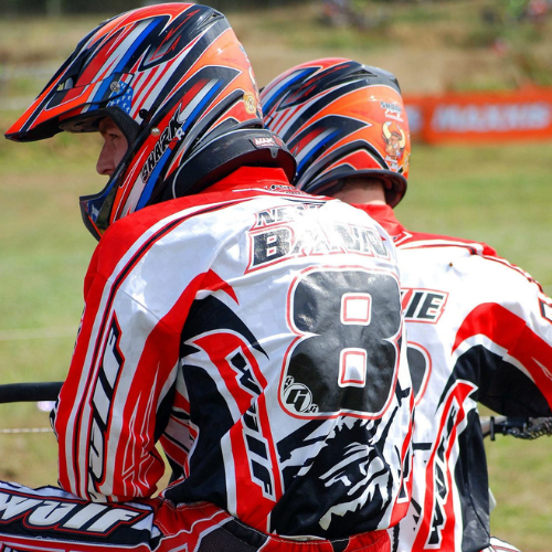 Man wearing red and white wulfsport jersey and helmet