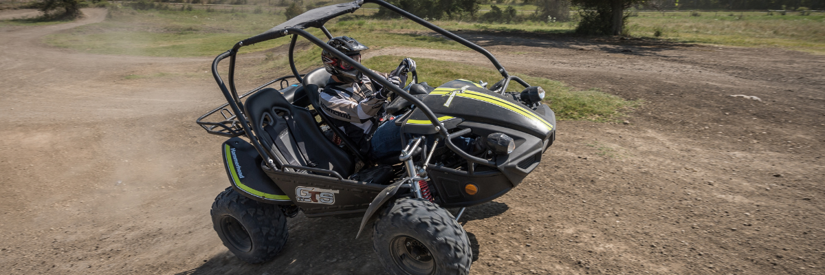 Man driving a GTS150 off road buggy on a dirt track