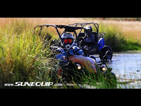 2 men driving a GTS150 buggies in a small stream