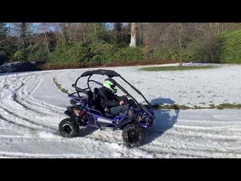 man driving a Mudhead buggy in the snow